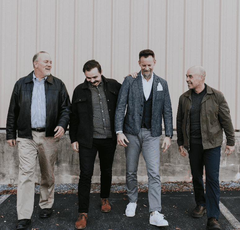 Four men with balanced hormones standing together