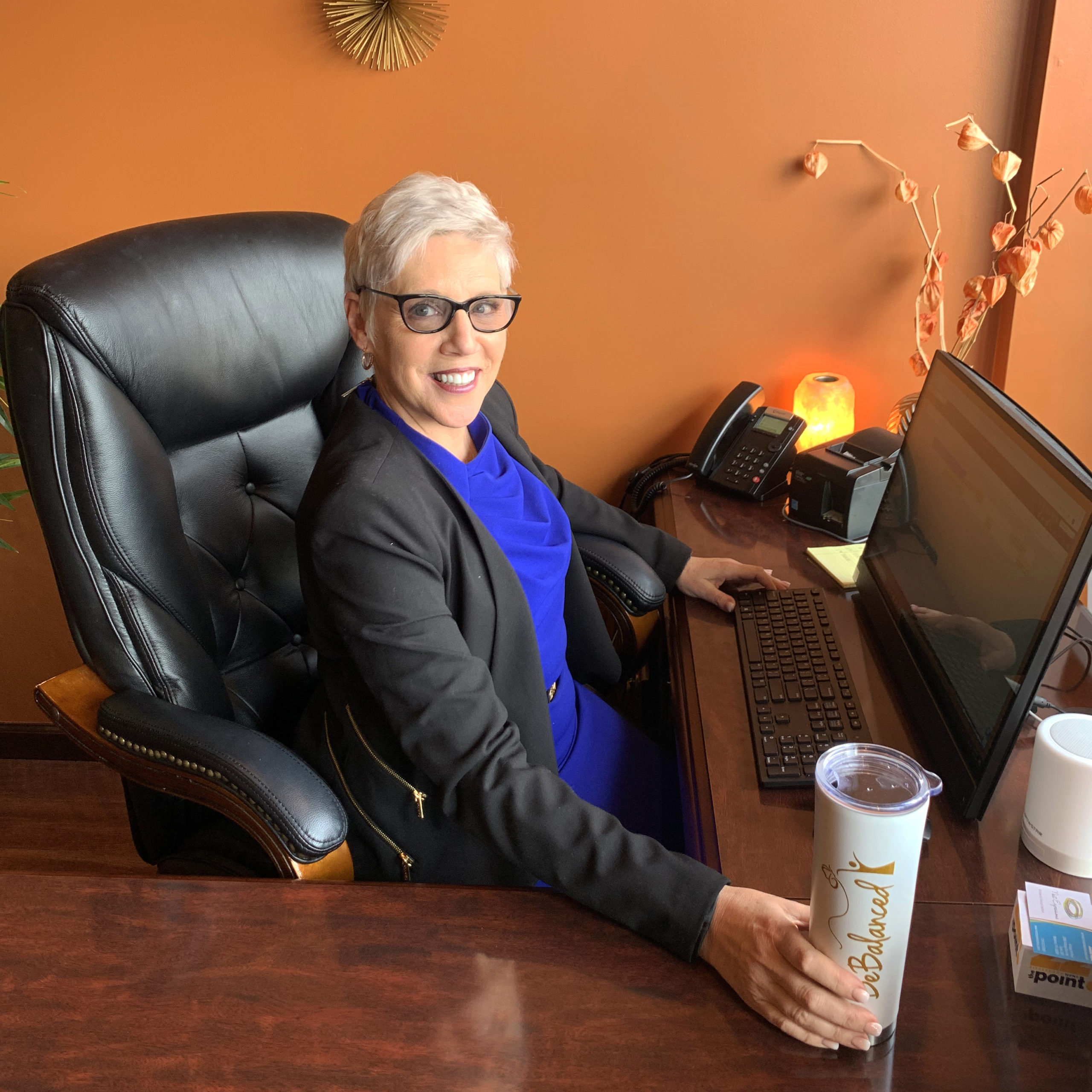 BeBalanced weight loss consultant sits behind computer