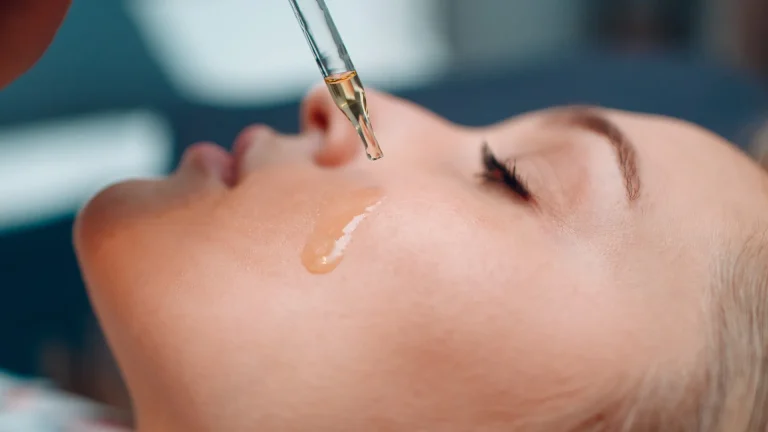 Beauty Oils That Meet Seasonal Challenges - woman putting beauty oil on her face