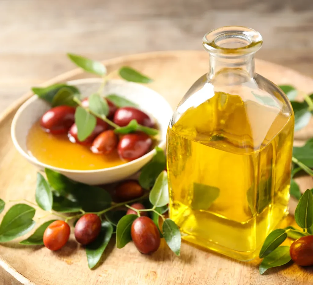 jojoba oil in a glass jar sitting on wooden table