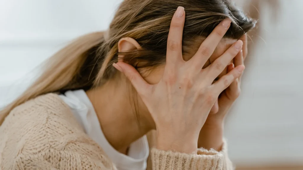 Stressed woman with her hands on her head