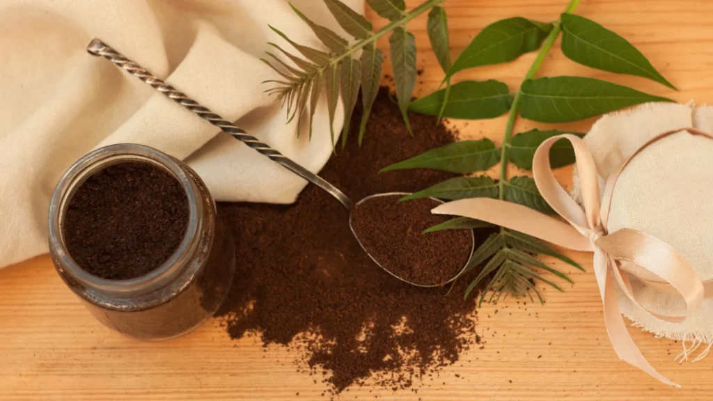 Coffee grounds scattered next to a cup and a bag