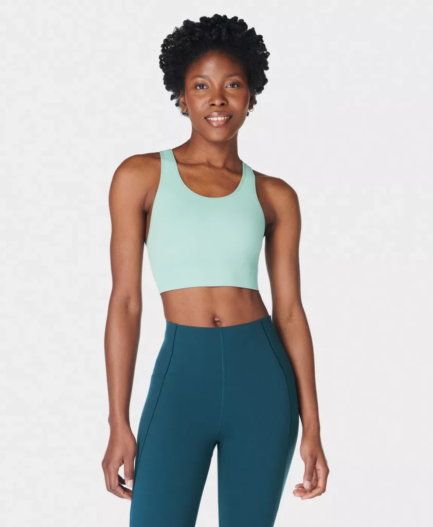 Woman with the Sweaty Betty Stamina Sports bra in an aqua color